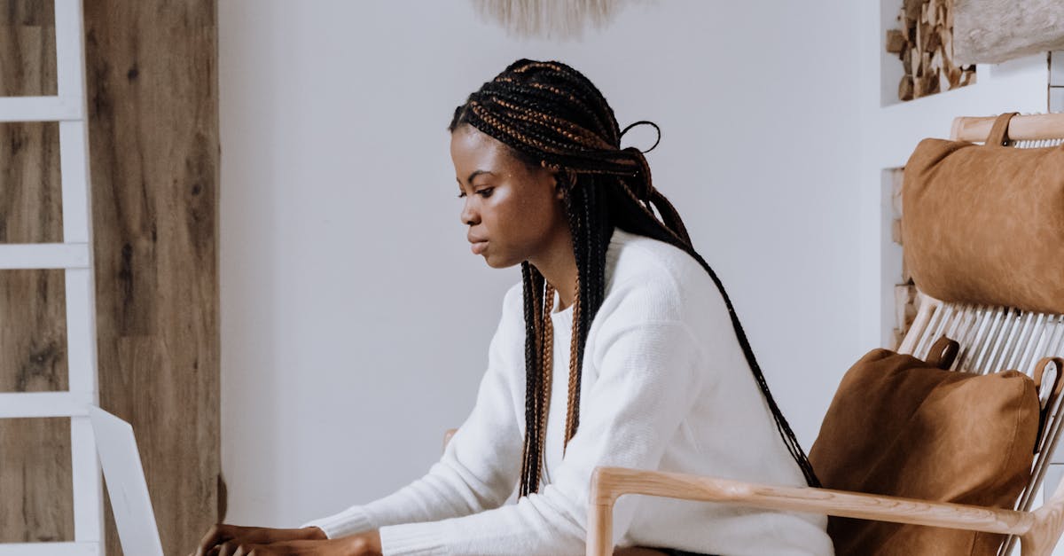 Woman in White Long Sleeve Shirt Sitting on Brown Wooden Chair